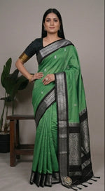 Load image into Gallery viewer, Green and black saree with silver border worn by a woman, displayed from different angles.