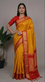 Load image into Gallery viewer, Woman wearing a yellow and red saree with a gray background