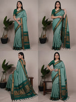 Load image into Gallery viewer, Woman wearing a green saree with a plant in the background