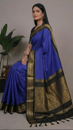 Load image into Gallery viewer, Blue saree with black and gold border worn by a model, displayed in multiple angles.