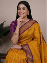 Load image into Gallery viewer, Woman wearing a yellow and purple saree with plants in the background