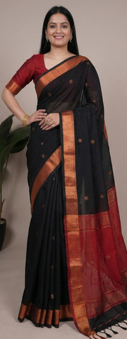 Black and red saree with gold border displayed by a model against a neutral background.