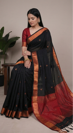 Load image into Gallery viewer, Black and red saree with gold border displayed by a model against a neutral background.
