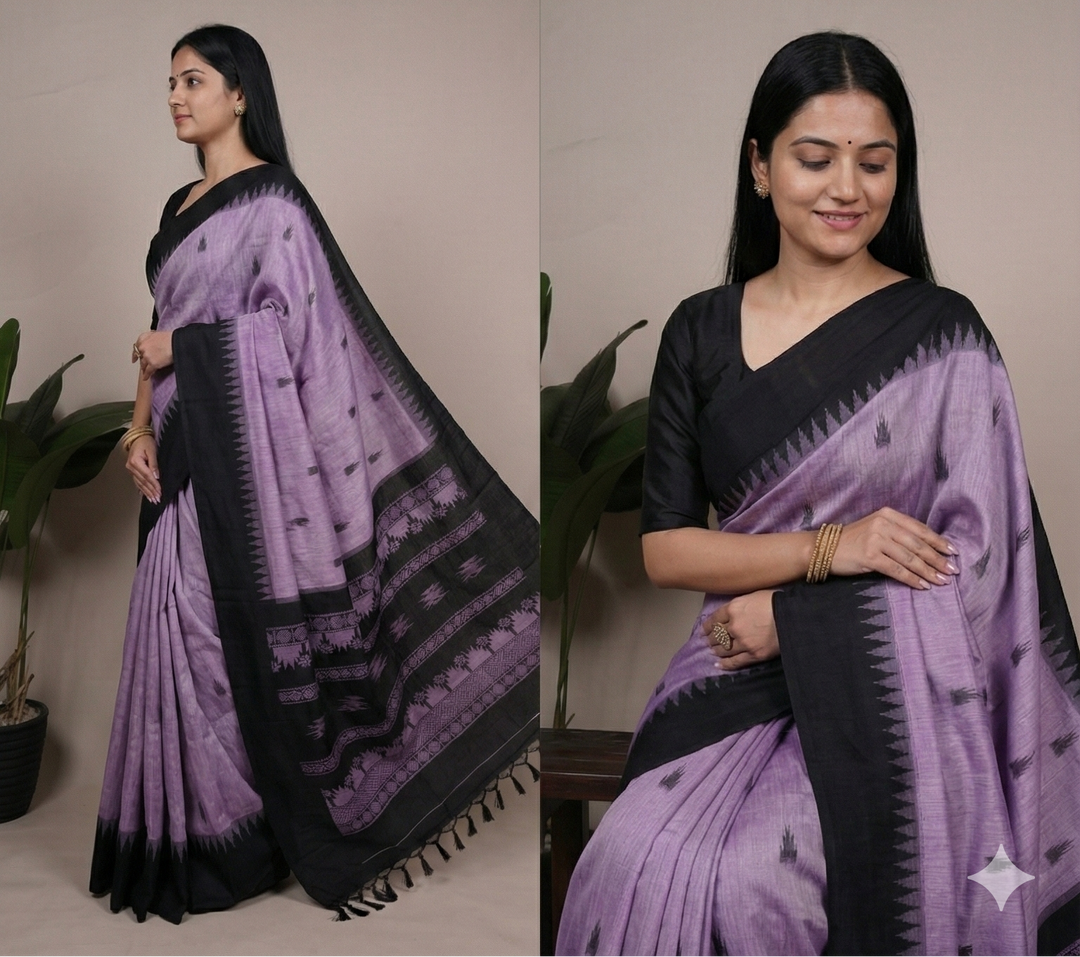 Woman wearing a purple and black saree with a plant in the background