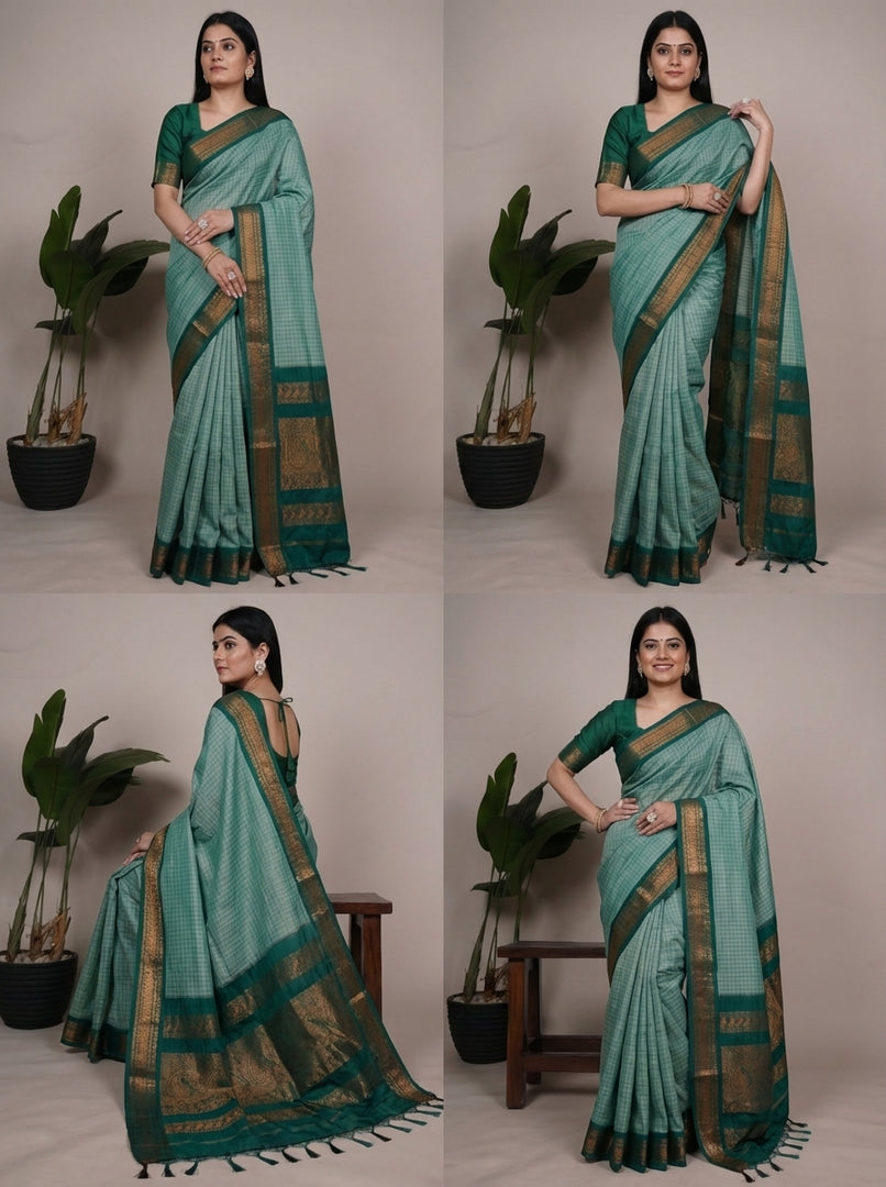 Woman wearing a green saree with a plant in the background