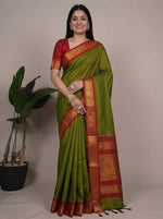 Load image into Gallery viewer, Woman wearing a green and red saree with a plain background