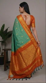 Load image into Gallery viewer, Green and orange saree with a woman modeling it in different poses against a neutral background.