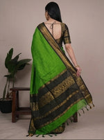 Load image into Gallery viewer, Green saree with black border worn by a model against a neutral background