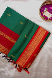 Green and red saree with gold patterns on a white surface, featuring 'Premium Kalyani/Gadwal Silk Cotton' branding.