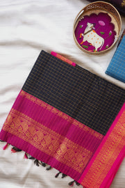 Black and pink checkered fabric with gold border on a white surface, featuring 'Deepa's Boutique' branding.